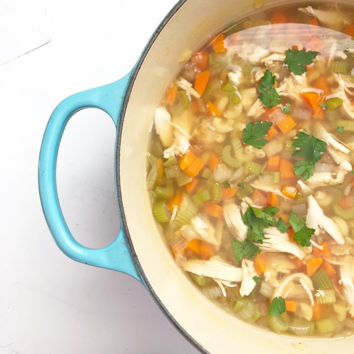 chicken noodle soup in teal dutch oven
