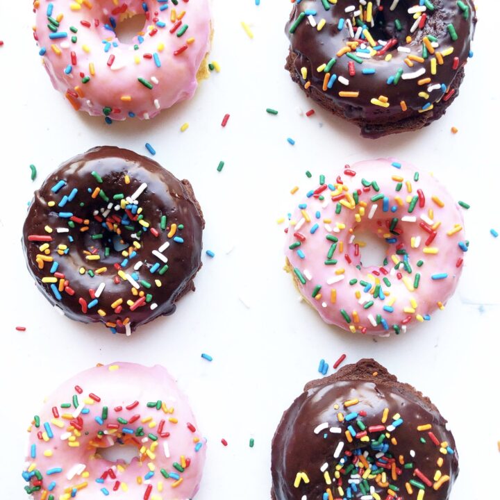 pink iced and chocolate iced donuts with multicolored sprinkles.