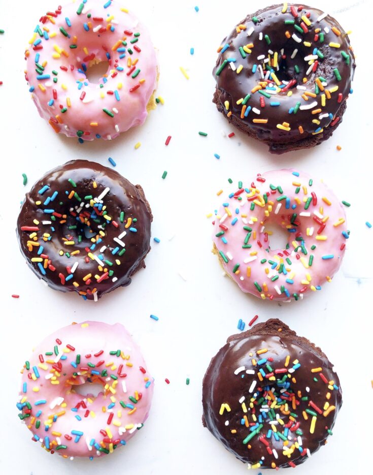 pink iced and chocolate iced donuts with multicolored sprinkles.