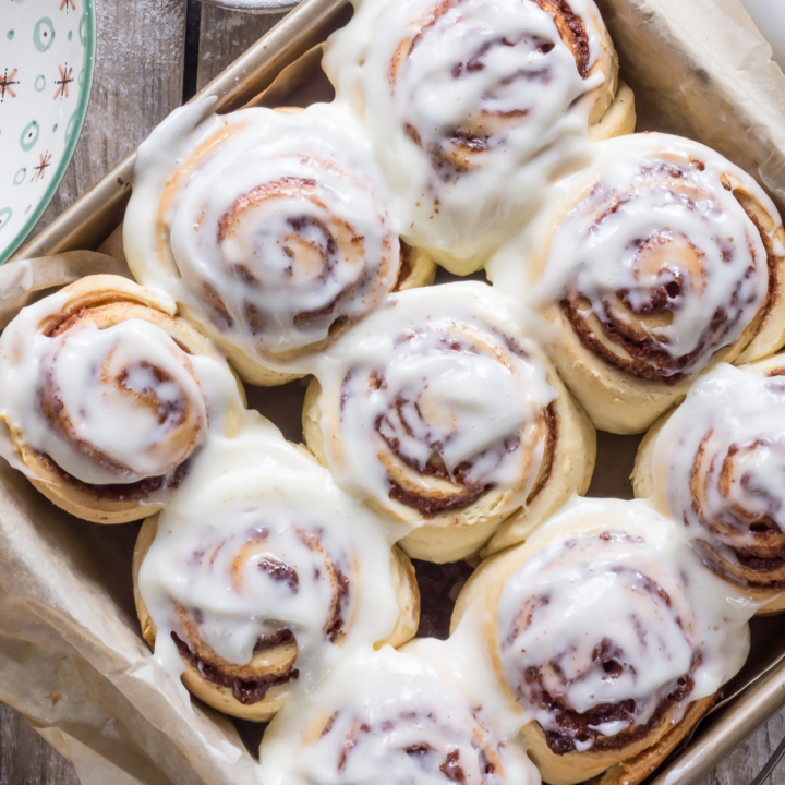 sourdough cinnamon rolls with icing in a pan