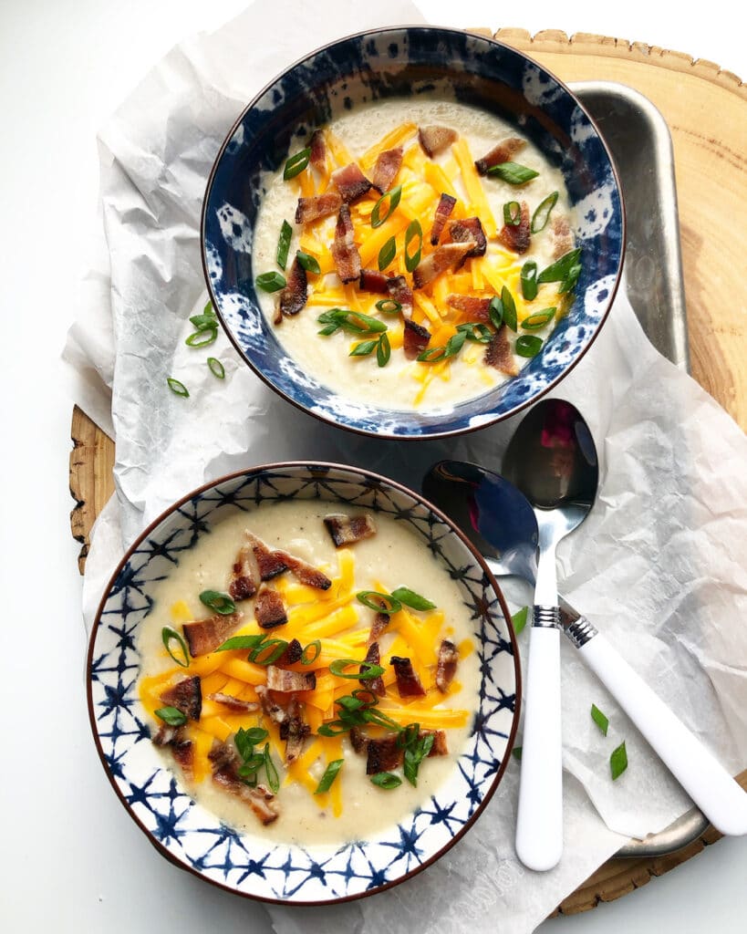 Loaded potato soup in bowls with spoons