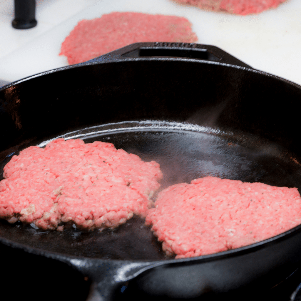 cooking burgers in cast iron skillet