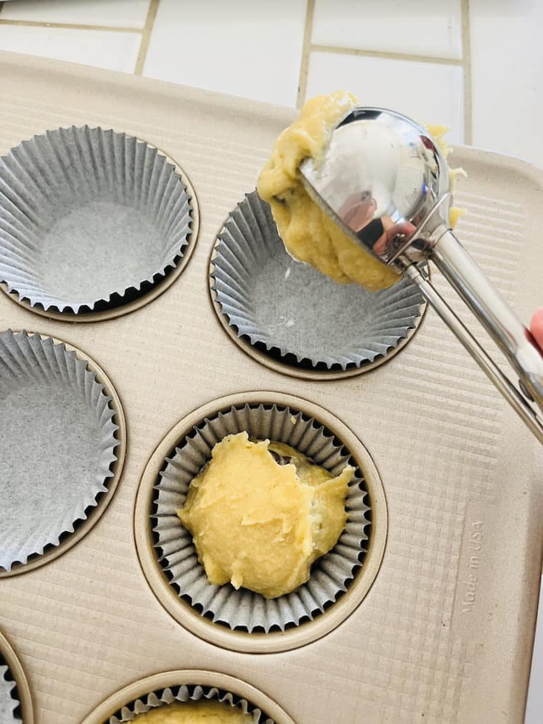 scooping the batter into muffin tins