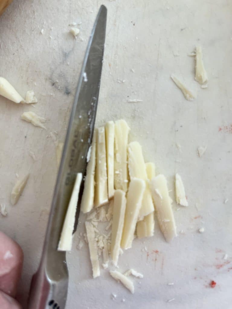 cutting the white chocolate for the cheese